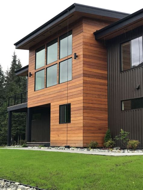 black metal siding house light wood|siding that looks like wood.